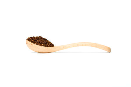 A chili flakes in a wooden spoon isolated over white backgroundの写真素材