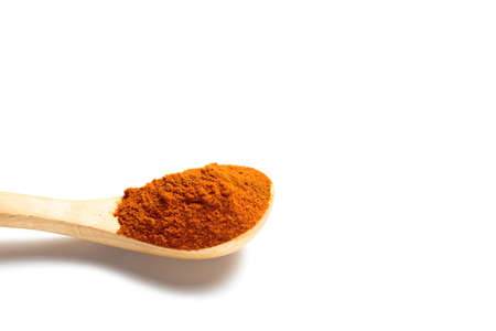 A curry powder in a wooden spoon isolated over white backgroundの写真素材
