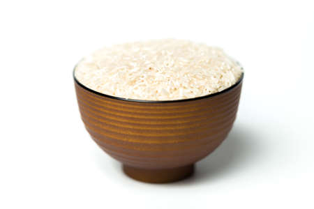 A rice in a bowl isolated over white backgroundの写真素材