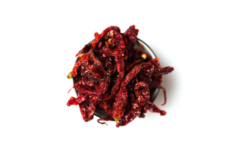 Dried chillies in a bowl isolated over white backgroundの写真素材