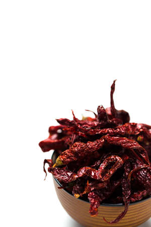 Dried chillies in a bowl isolated over white backgroundの写真素材