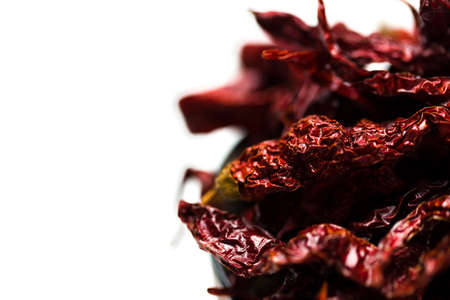 Dried chillies in a bowl isolated over white backgroundの写真素材