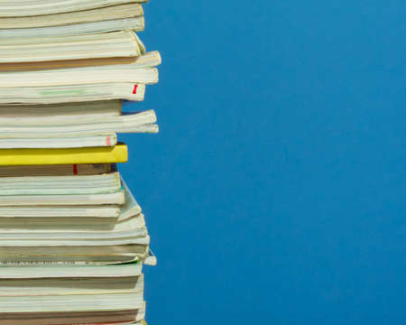 Pile of old magazines with blue color backgroundの写真素材