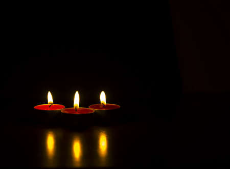 Isolated burning candles with black background