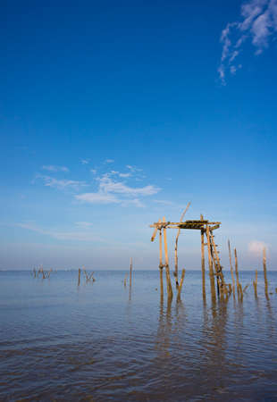 Nice view of old wooden platform on calm sea with beautiful blue sky background の写真素材