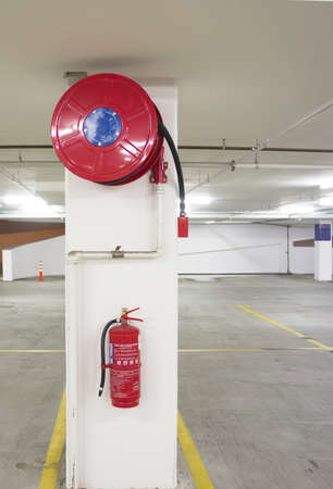 Fire extinguisher and fire hose installed at pillar 