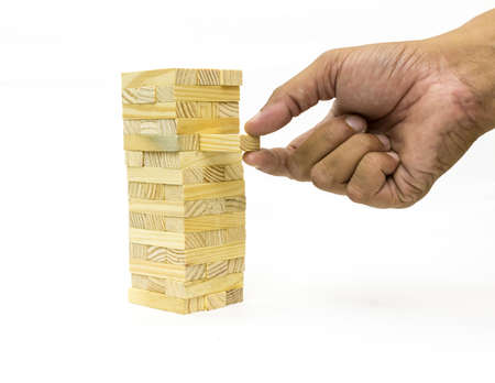 Isolated hand playing with the wood game on white background の写真素材