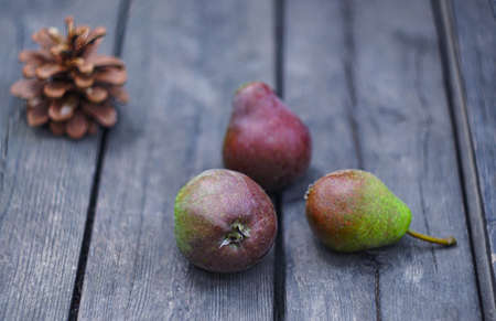 There are green apples and pears on the tableの写真素材