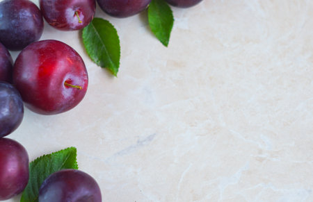 There are plums in the red bowl