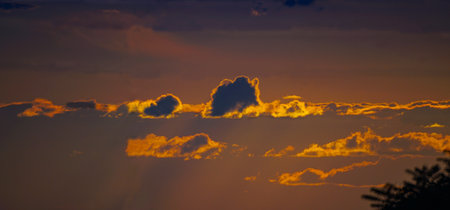 A dark cloud is reddening in the sunlight