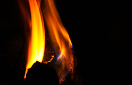A fire burns in the dark