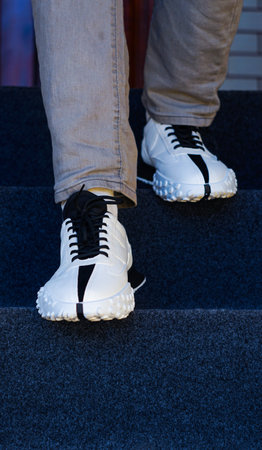 the man has white sneakers on his feet