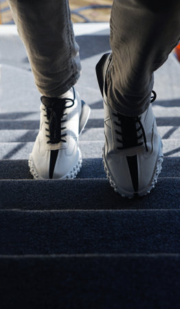 the man has white sneakers on his feetの写真素材