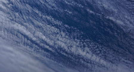 White clouds spread like waves in the blue sky