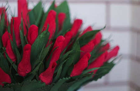 There is a paper bouquet in front of the windowの写真素材