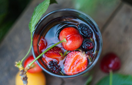 Juice and various fruits are scattered on the boardの写真素材