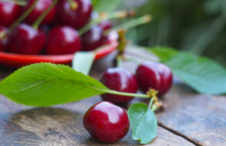 There is a big red cherry on the boardの写真素材