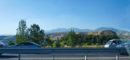 You can see cars passing by the side of the road