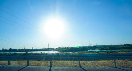 Trees and mountains along the road can be seen blue skyの写真素材