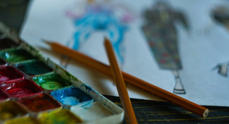 Paint and paper pencils on the table