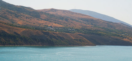 A distant village can be seen at the foot of the mountainの写真素材