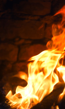 The fire burns red in the hearth