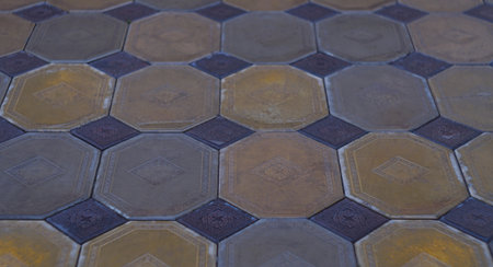 The cement tiles laid on the pavement are of different shapes