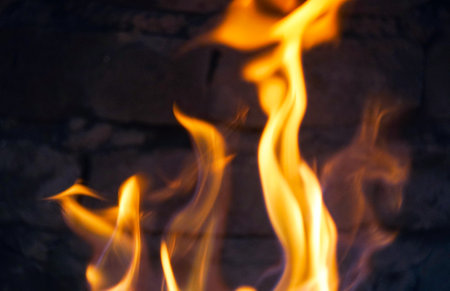 The fire burns red in the hearthの写真素材