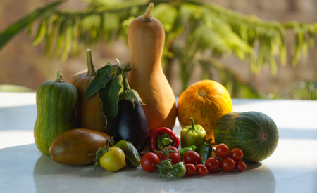 There are zucchini, tomatoes and other vegetables on the table.の写真素材