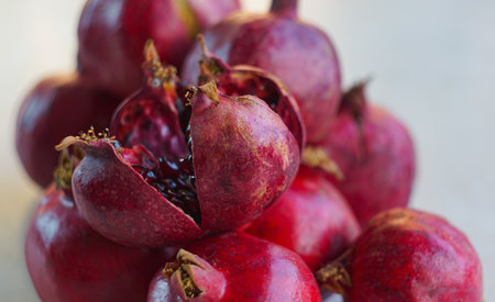 Large pomegranates were piled up on the table.の写真素材