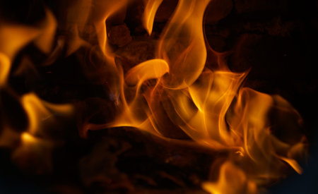 The appearance of a burning red flame on a black backgroundの写真素材