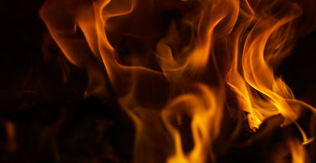 The appearance of a burning red flame on a black backgroundの写真素材