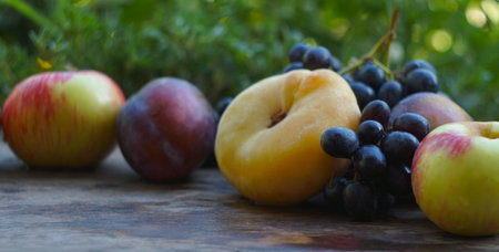 On the board are black grapes and various fruits.