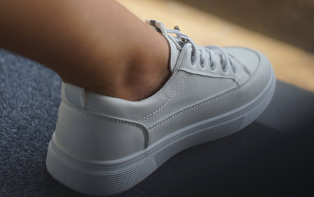 The girl is wearing white sneakers.の写真素材