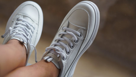 The girl is wearing white sneakers.の写真素材