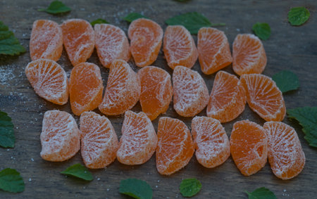 Dried tangerine slices scattered on a boardの写真素材