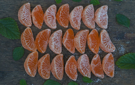 Dried tangerine slices scattered on a boardの写真素材