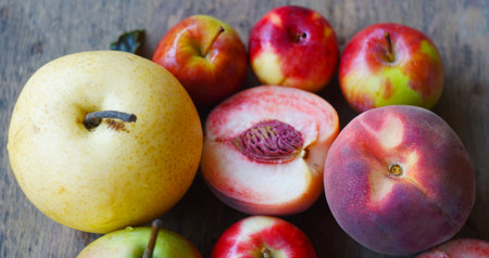 Pears, peaches, and apples are picked on the board.