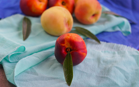 Smooth peaches are piled up on the boardの写真素材