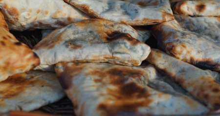 There are rows of baked breads on the table.