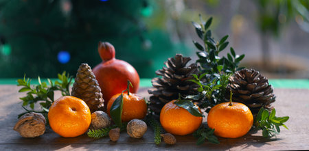 Tangerines and fir nuts on the table. New Year's table