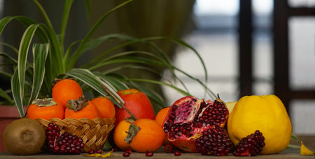 There are flowers and various fruits in front of the window, and among the fruits is a cut...