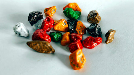Colorful chocolate pebble candies macro sweet snack texture background vibrant glossy candy pieces for dessert decoration food concept and creative backgroundの写真素材