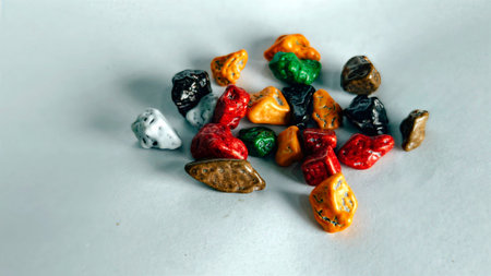 Colorful chocolate pebble candies macro sweet snack texture background vibrant glossy candy pieces for dessert decoration food concept and creative backgroundの写真素材