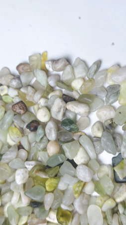 Natural green pebble stones texture background with organic mineral colors and smooth small rocks...