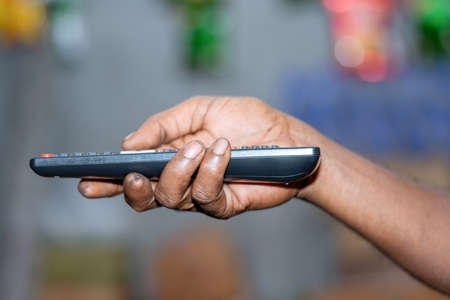 Hand holding Multimedia remote control