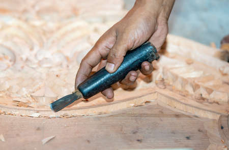 close-up carpenter man's hand treats the tree, cuts the shavings. Copy space. woody curl. Manual...