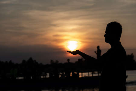 male  and orange sky and sun set