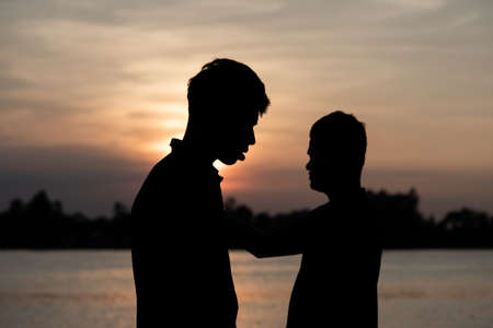 male  and orange sky and sun set