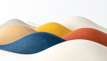 Close-up of undulating, rounded forms in an array of muted, saturated colors set against a pure white background. The shades include blue, yellow, and redの素材
